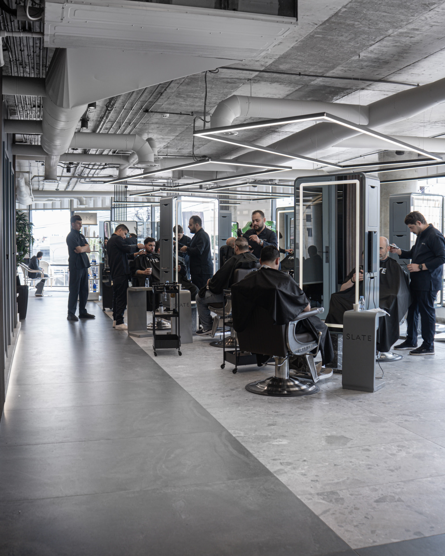 The SLATE salon floor with barbers at work