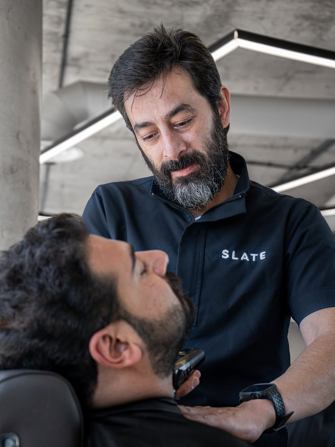 Beard trim in progress at SLATE
